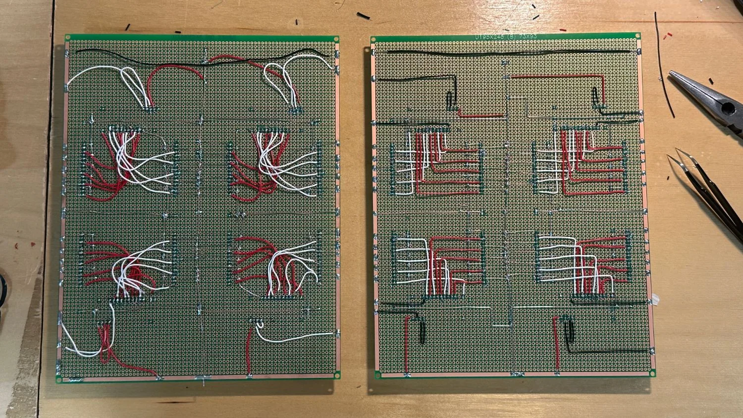 Two soldered perfboards. Red and white wires converge on four Nano sockets.